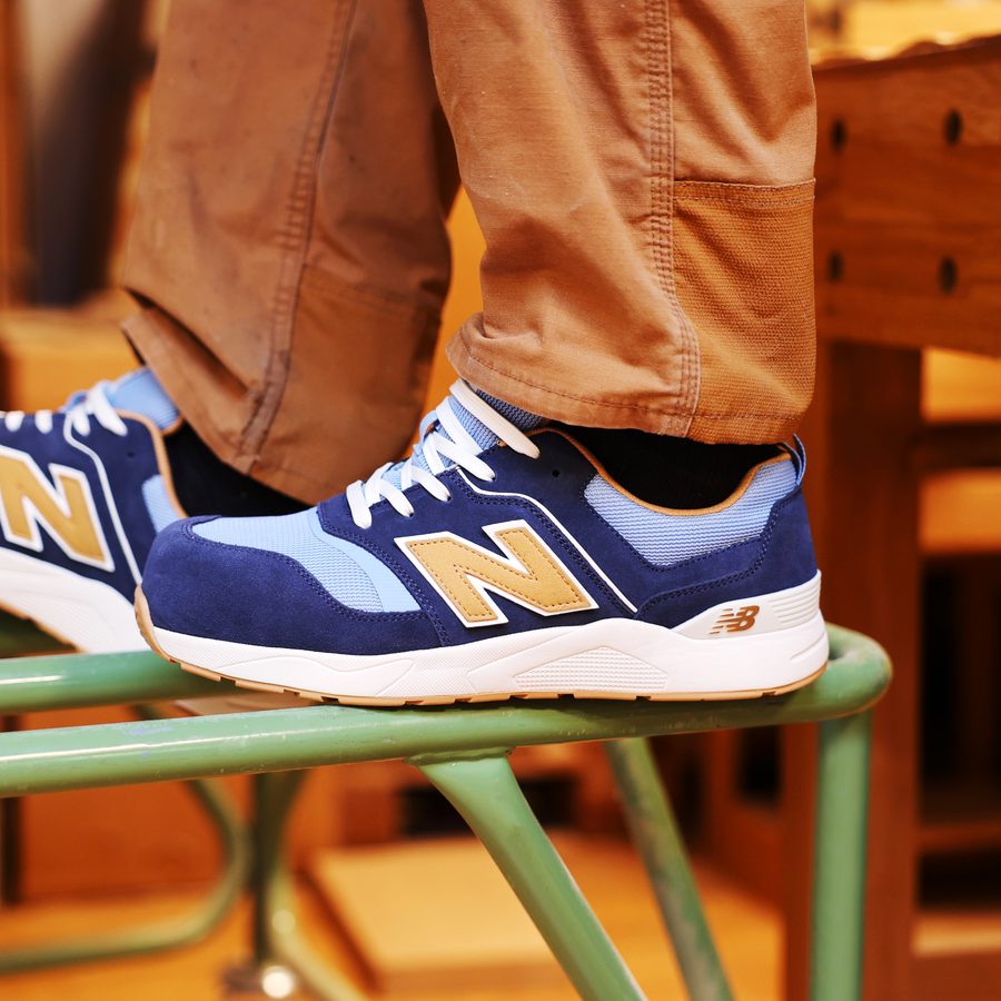 New Balance Elite Lite safety trainer on stacked timber